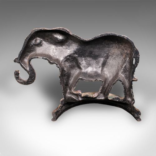 fig 3. A Victorian cast iron doorstop depicting an elephant with its trunk raised standing on a painted oval base.