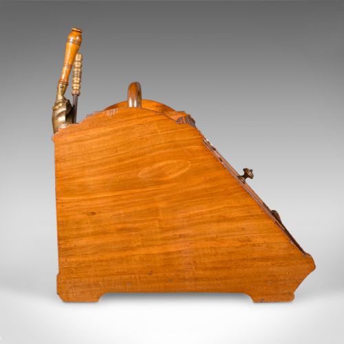 fig 4. A Victorian walnut coal purdonium with panelled slant-front doors, a brass carrying handle, and an attached shovel mounted at the back.