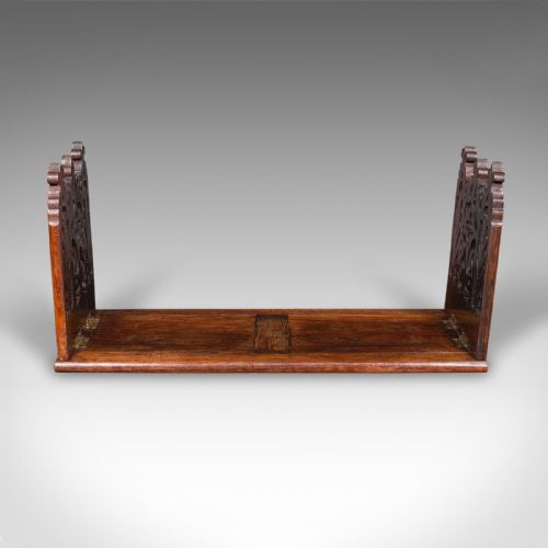 fig 2. A dark oak Victorian extending book slide featuring pierced Gothic fretwork carved ends hinged to an adjustable base.