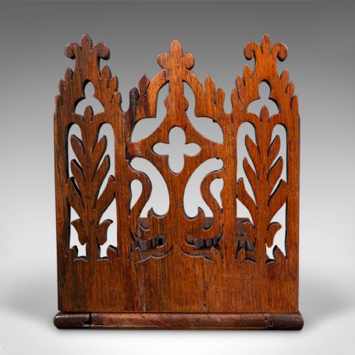 fig 3. A dark oak Victorian extending book slide featuring pierced Gothic fretwork carved ends hinged to an adjustable base.