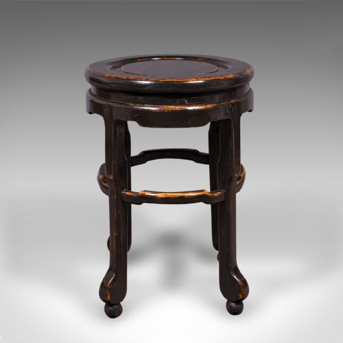 fig 2. An antique Japanese ebonised elm side table featuring an oval top, shaped stretchers, and curved legs.