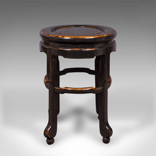 fig 3. An antique Japanese ebonised elm side table featuring an oval top, shaped stretchers, and curved legs.