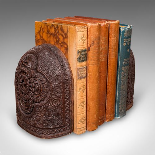 fig 1. A pair of arch-topped antique beech wood bookends decorated with intricate foliate and floral relief carvings.