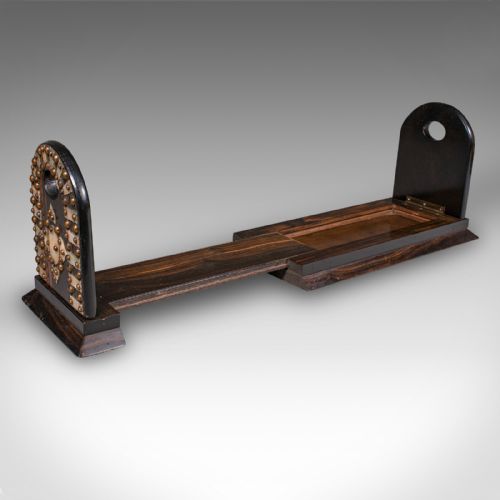 fig 1. An antique Regency coromandel wood extending book slide featuring mother-of-pearl inlay and brass stud detailing on folding arched ends.