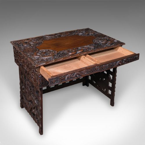 fig 1. A dark brown carved teak folding altar table with deep dragon relief carvings surrounding a flat central top reserve.