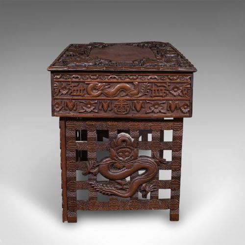 fig 3. A dark brown carved teak folding altar table with deep dragon relief carvings surrounding a flat central top reserve.
