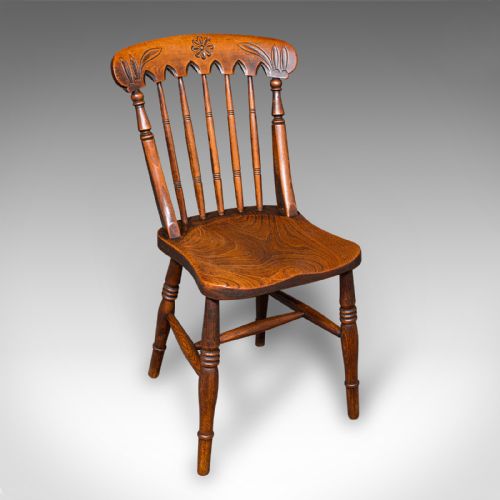 fig 1. A set of three Victorian wooden side chairs featuring carved backrails, turned spindles, and contoured elm seats.