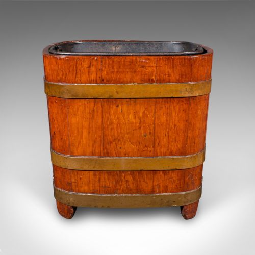 fig 2. A square warm brown wooden coal bucket featuring brass binding bands and an internal black metal liner.