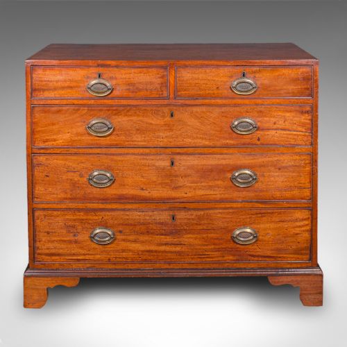 fig 2. A late 18th-century Georgian mahogany chest of drawers featuring two short drawers above three long drawers with oval brass handles on bracket feet.