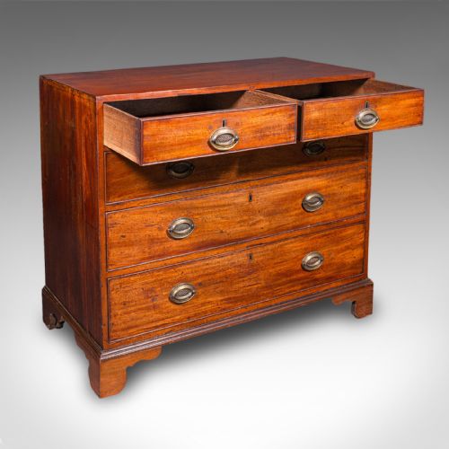 fig 3. A late 18th-century Georgian mahogany chest of drawers featuring two short drawers above three long drawers with oval brass handles on bracket feet.