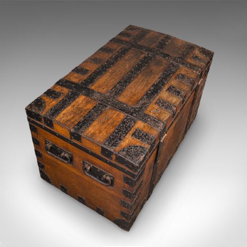 fig 6. A large Victorian oak silver chest reinforced with heavy black iron straps, riveted corner brackets, side handles, and a central brass plate.