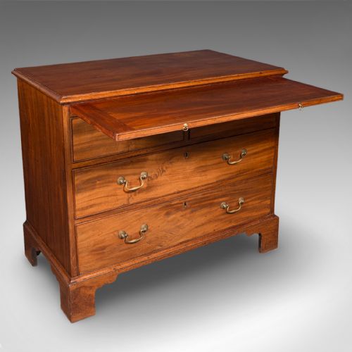 fig 1. An antique Georgian mahogany bachelors chest featuring a brushing slide above two short and two long drawers with brass swan neck handles and bracket feet.
