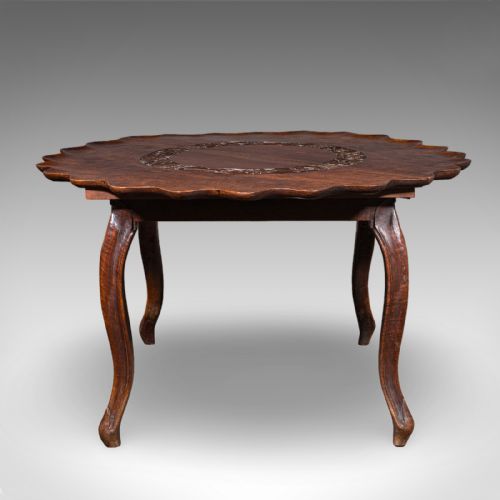 fig 1. An Anglo-Indian carved dark hardwood circular dining table featuring a scalloped piecrust edge, incised top detailing, and cabriole legs.