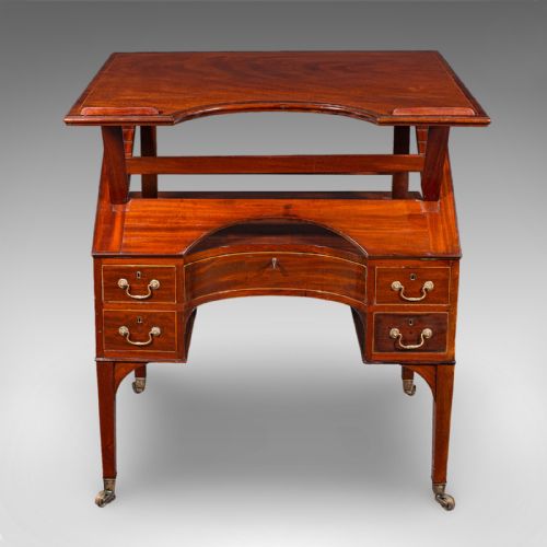 fig 4. A Regency mahogany metamorphic architects desk featuring an adjustable tilted top on ratchet risers above a kneehole drawer base with brass handles.