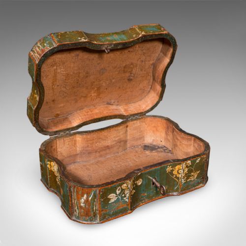 fig 1. An antique serpentine-shaped green lacquered table box decorated with hand-painted yellow flowers and fitted with an iron key in the front lock.