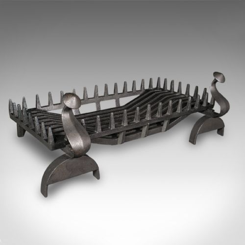 fig 1. An antique dark charcoal iron fire basket featuring a spiked rail and matching end supports with domed finials on arched feet.