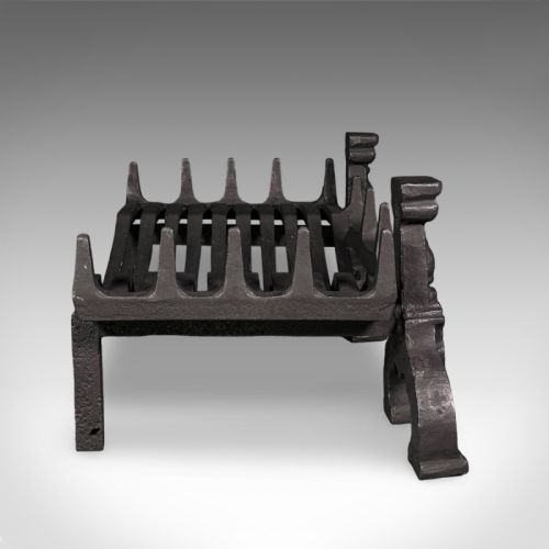 fig 2. A Victorian cast iron fire basket featuring a slatted cradle resting on decorative firedog supports with baluster columns and curved feet.