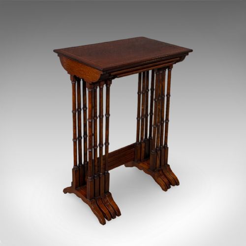 fig 1. A set of four Edwardian mahogany quartetto nesting tables arranged in a stepped row, featuring delicate turned legs, decorative boxwood inlay, and shaped stretchers.