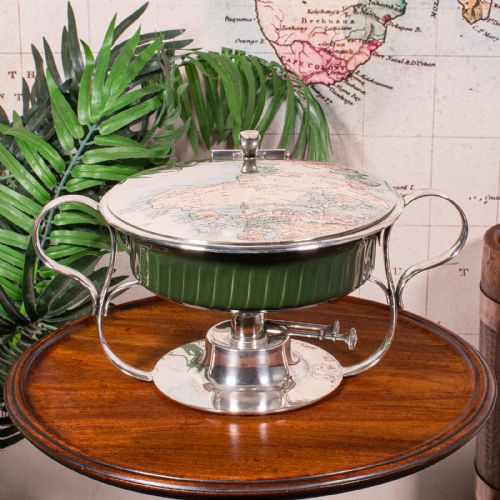 fig 2. An Edwardian silver-plated chafing dish featuring a ribbed green ceramic liner, double loop handles, a fitted lid, and an integrated spirit burner base.