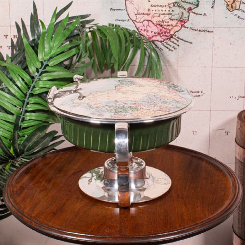 fig 3. An Edwardian silver-plated chafing dish featuring a ribbed green ceramic liner, double loop handles, a fitted lid, and an integrated spirit burner base.