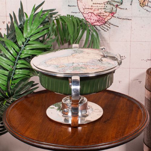 fig 4. An Edwardian silver-plated chafing dish featuring a ribbed green ceramic liner, double loop handles, a fitted lid, and an integrated spirit burner base.