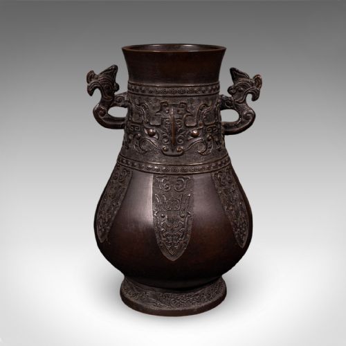 fig 1. A dark patinated bronze Hu vase featuring archaistic relief carvings and twin dragon handles dating to around 1880.
