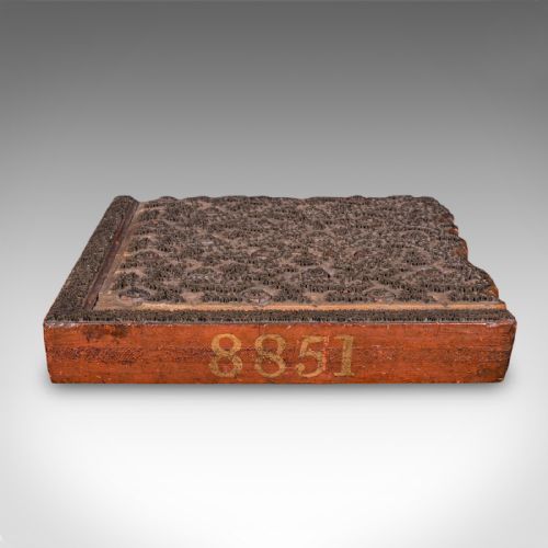 fig 1. A square Victorian wooden wallpaper printing block crafted from dark wood with raised brass pins forming a repeating pattern.
