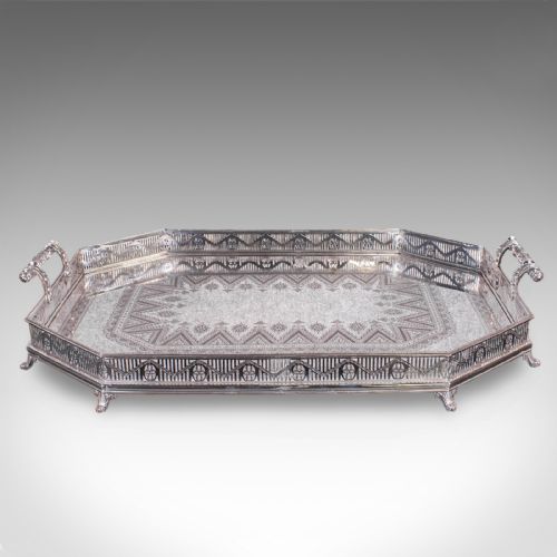 fig 1. A Victorian silver-plated presentation tray featuring geometric surface engraving, a pierced gallery border, twin side handles, and scroll feet.