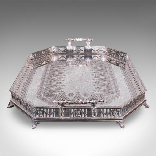 fig 2. A Victorian silver-plated presentation tray featuring geometric surface engraving, a pierced gallery border, twin side handles, and scroll feet.