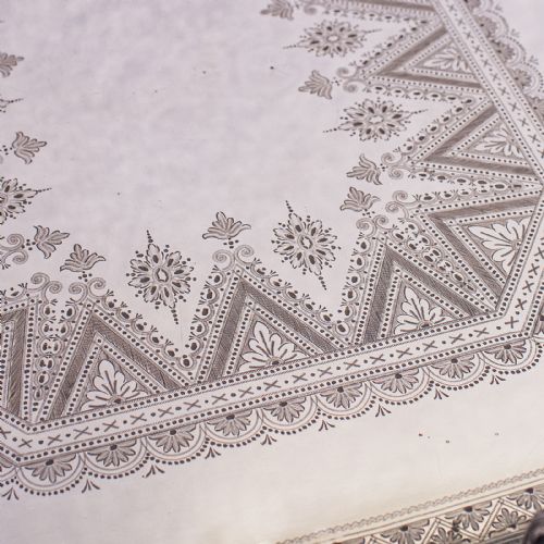 fig 5. A Victorian silver-plated presentation tray featuring geometric surface engraving, a pierced gallery border, twin side handles, and scroll feet.