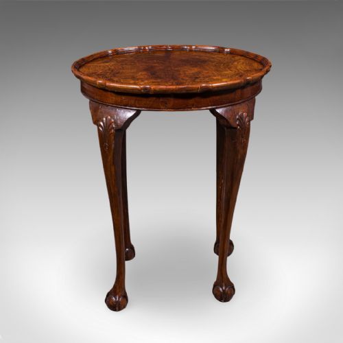 fig 1. An Edwardian burr walnut oval side table featuring a raised pie crust edge and carved cabriole legs.