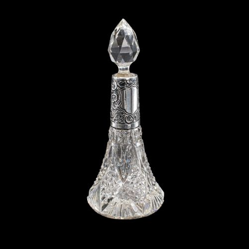 fig 2. A pair of conical cut crystal scent bottles featuring embossed silver collars and faceted glass stoppers.