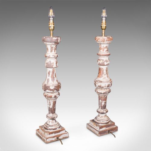 fig 2. A pair of tall turned pine table lamp bases with heavily distressed grey-white paint revealing natural timber beneath.