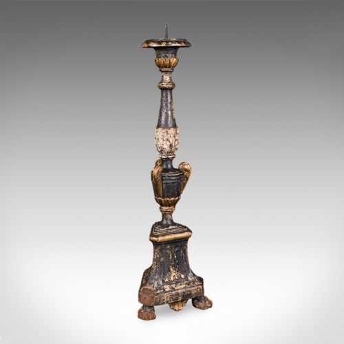 fig 2. A tall Georgian ebonised and giltwood candle pricket featuring a turned baluster stem, urn detail, and a stepped square base resting on claw feet.