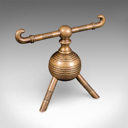 fig 3. A pair of late Victorian brass fireside tool rests featuring ribbed spherical central bodies, tripod legs, and hooked horizontal crossbars.