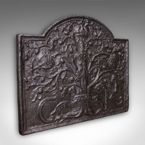 fig 1. A rectangular dark cast iron fireback with an arched central top featuring a raised relief of the Royal Oak tree motif.