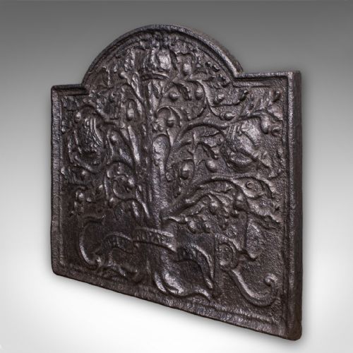 fig 2. A rectangular dark cast iron fireback with an arched central top featuring a raised relief of the Royal Oak tree motif.