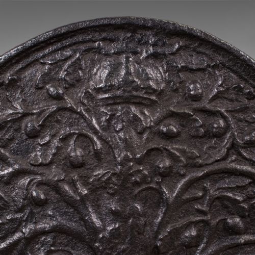 fig 3. A rectangular dark cast iron fireback with an arched central top featuring a raised relief of the Royal Oak tree motif.