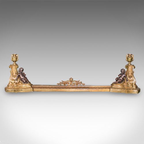 fig 1. An 1880 Victorian adjustable gilt bronze fireplace fender featuring classical urn finials and sitting cherub figures at either end.