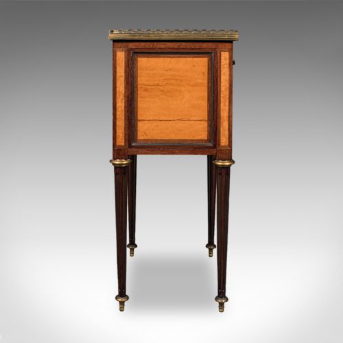 fig 3. A French Louis XVI Revival walnut bedside table with three marquetry drawers, a brass gallery rim, and tapered legs.