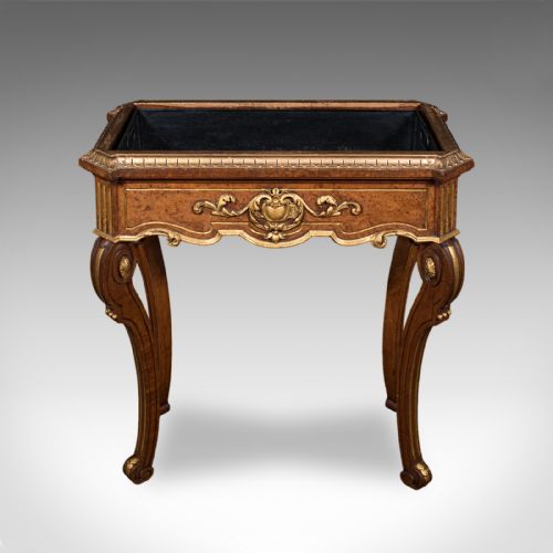 fig 2. An antique French walnut jardiniere table featuring gilded carved mounts, cabriole legs, and a dark recessed internal liner.