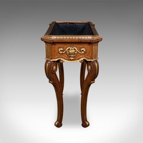 fig 3. An antique French walnut jardiniere table featuring gilded carved mounts, cabriole legs, and a dark recessed internal liner.