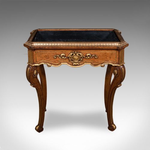 fig 4. An antique French walnut jardiniere table featuring gilded carved mounts, cabriole legs, and a dark recessed internal liner.