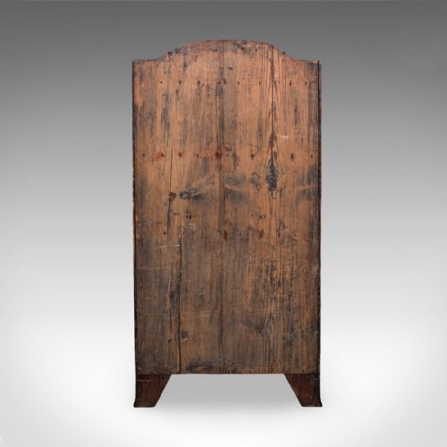 fig 4. An antique Georgian mahogany waterfall bookcase featuring two open receding upper shelves above a two-door base cupboard with a shaped apron.
