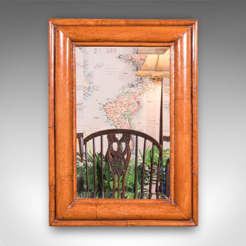 fig 1. An antique Edwardian rectangular wall mirror featuring a cushion-moulded warm brown walnut frame and a bevelled mirror plate.