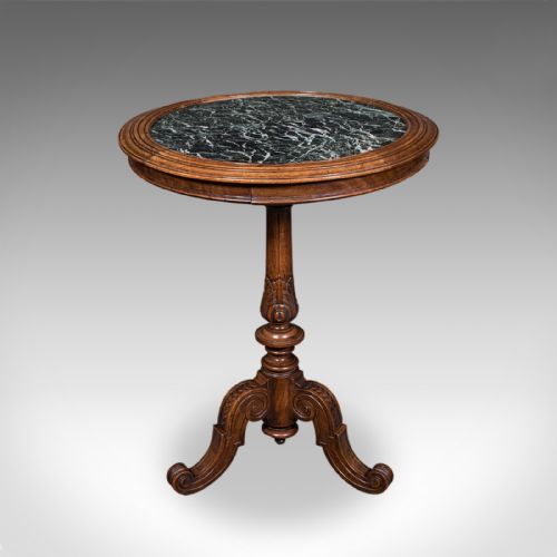 fig 1. A High Victorian walnut wine table with a circular green marble inset top set on a carved tripod pedestal base.