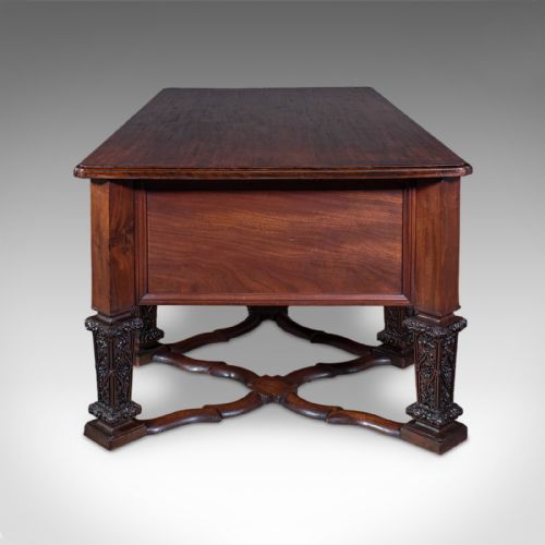 fig 2. A Victorian mahogany partners desk in the Louis XIV Revival style featuring curved pedestals, carved legs, x-frame stretchers, and multiple drawers with turned knobs.