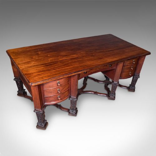 fig 5. A Victorian mahogany partners desk in the Louis XIV Revival style featuring curved pedestals, carved legs, x-frame stretchers, and multiple drawers with turned knobs.