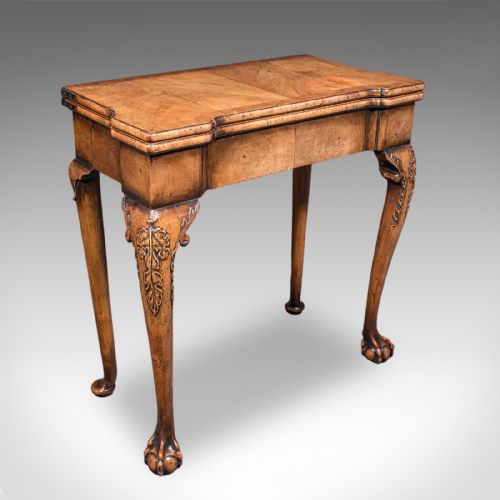 fig 1. An antique English Georgian walnut card table featuring cabriole legs with carved knees, claw and ball feet, and a square green baize playing surface.