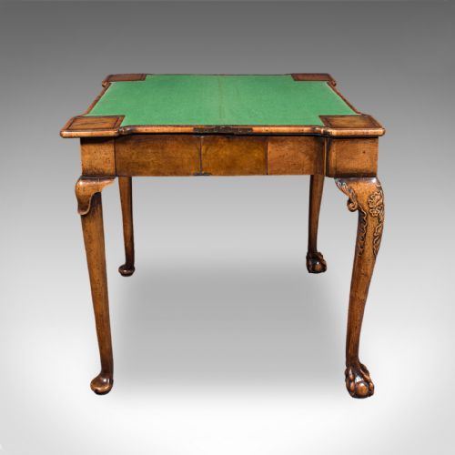 fig 2. An antique English Georgian walnut card table featuring cabriole legs with carved knees, claw and ball feet, and a square green baize playing surface.